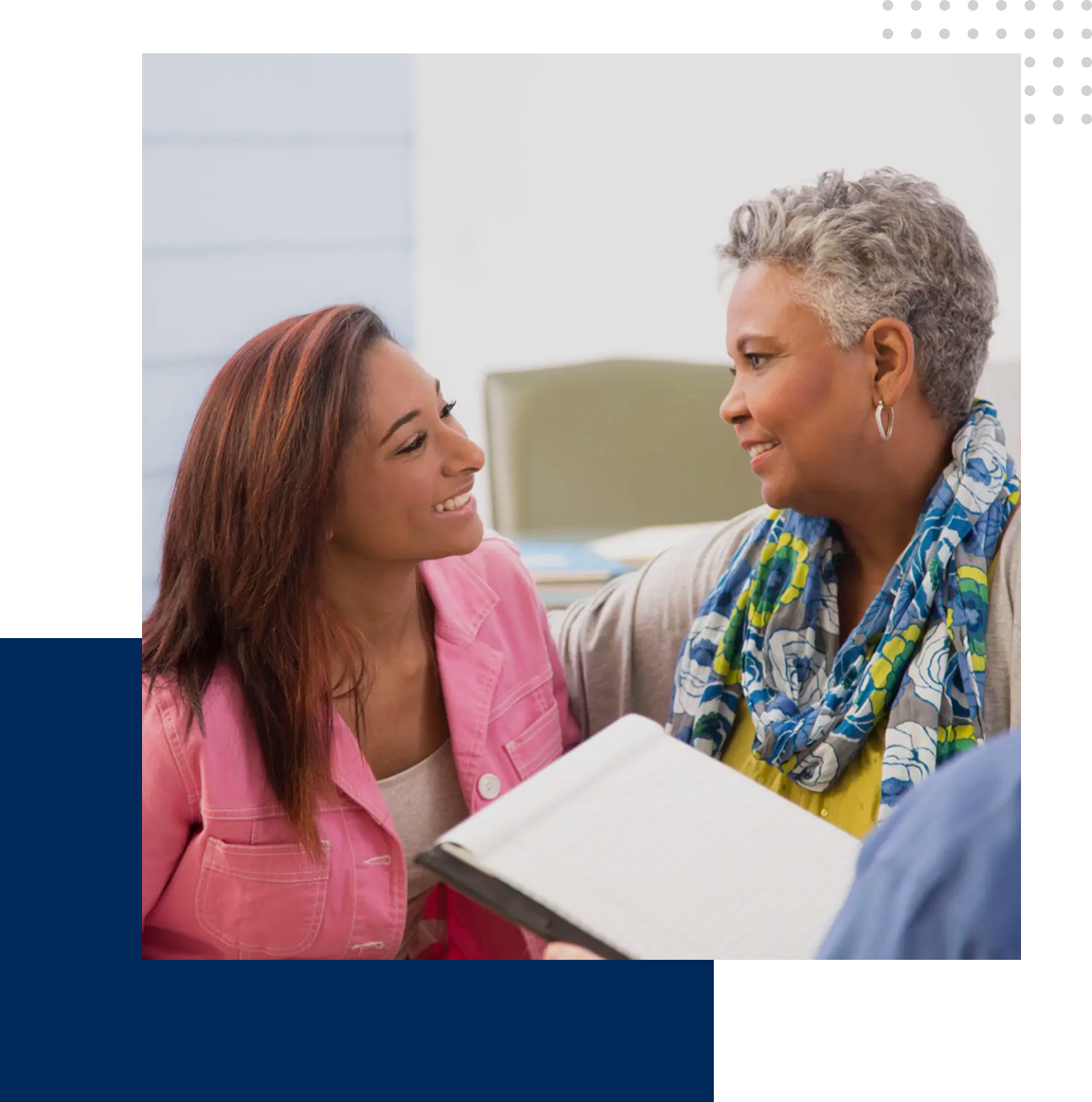 Two women sharing a joyful moment with a gift box.